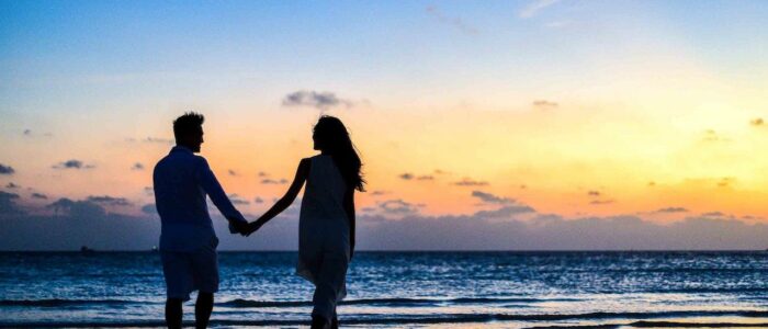 silhouette holding hands couple
